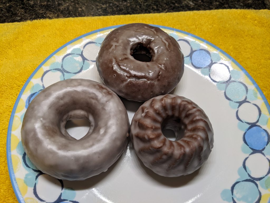 Finished traditional glazed chocolate donuts