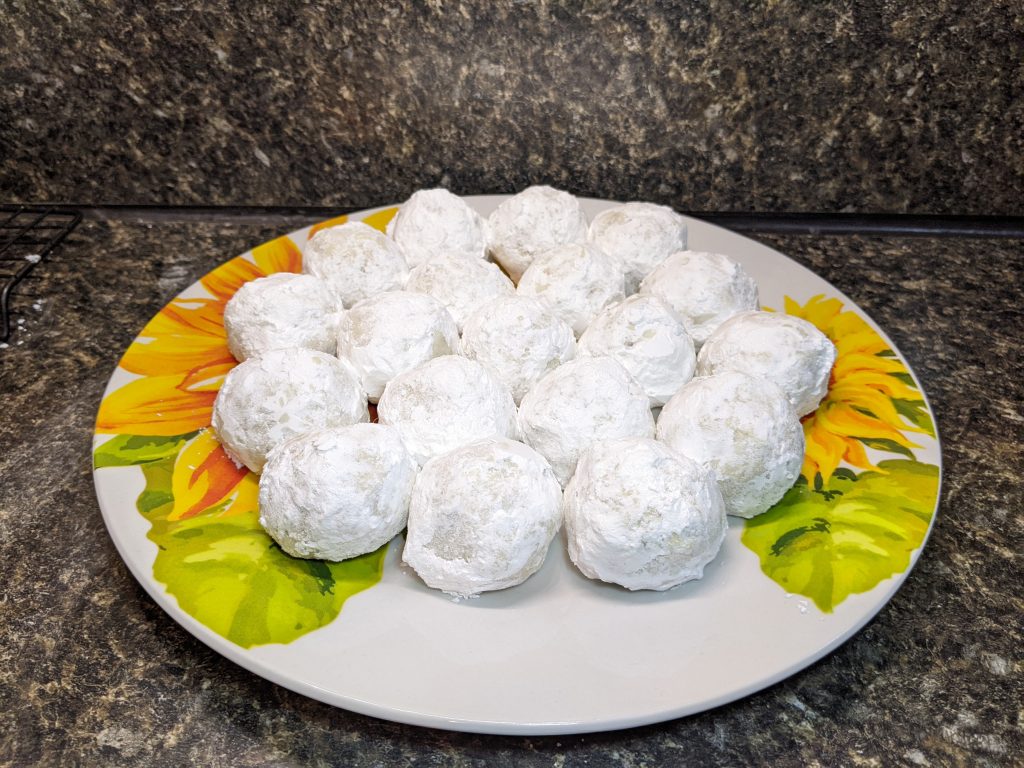 Finished snowball cookies on a tray