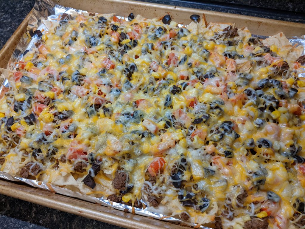 A sheet pan of baked nachos.