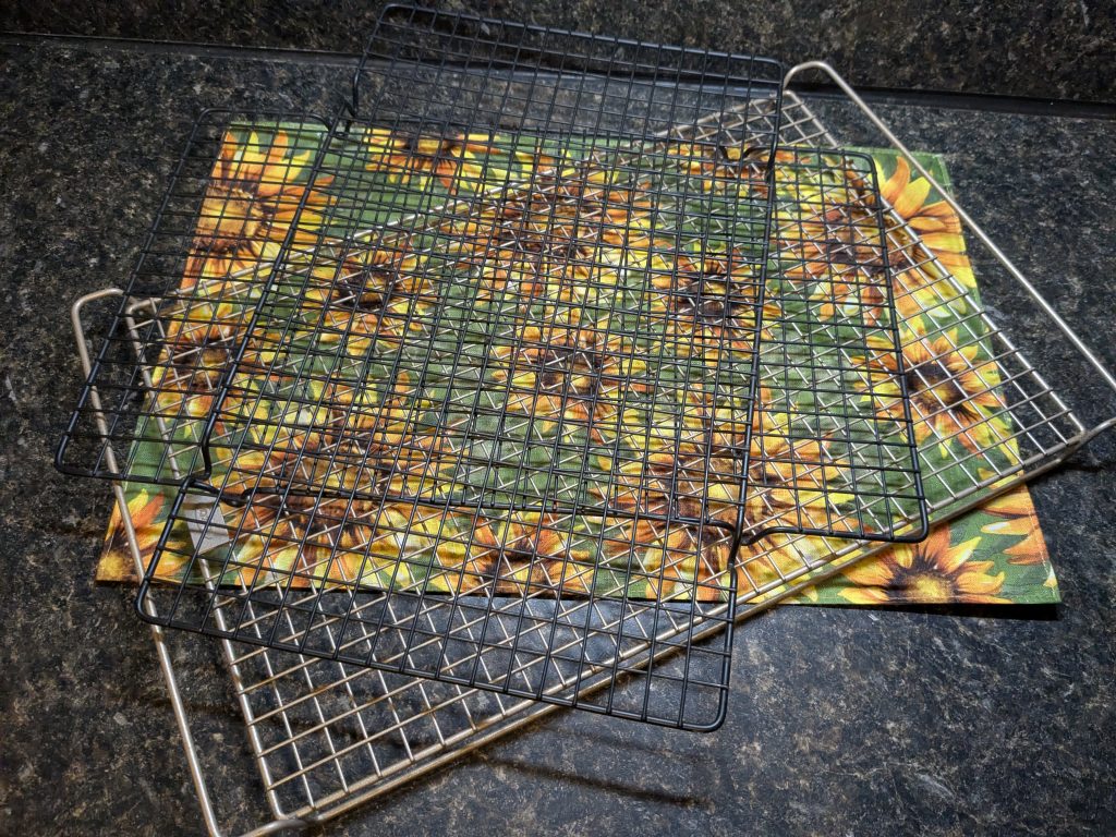 A photo of three wire cooling racks haphazardly stacked on top of each other.