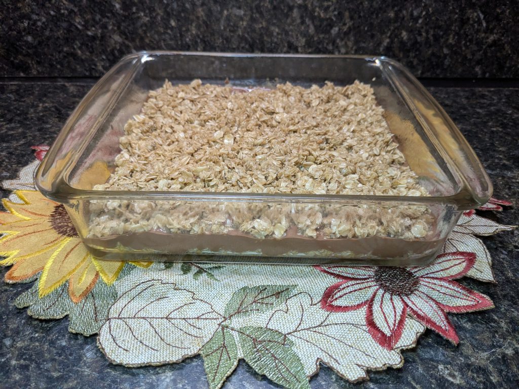 A picture of completed, layered no-bake bars in a baking dish.